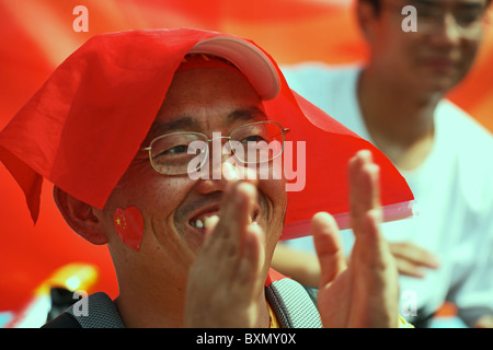 Man in Beach Volleyball audience, Beijing Olympics, China Stock Photo