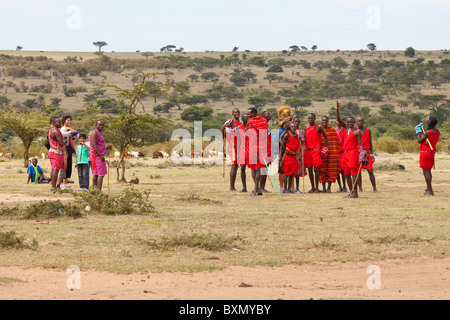 Tourtists visiting a Maasai village on the Masai Mara, Kenya Stock Photo
