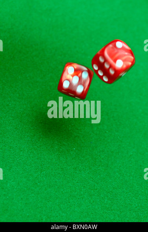 dice rolling on a green table Stock Photo