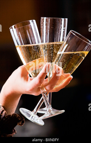 The glasses of champagne in the hand on the black background Stock Photo