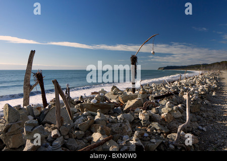 Wierd sculptures amongst the driftwood on a beach in the Haast region of New Zealand's South Island Stock Photo