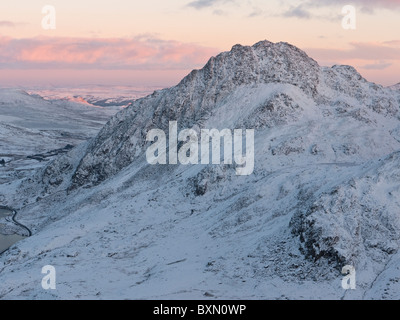 The snow-covered mountain of Tryfan in Snowdonia, seen during a winter sunset Stock Photo