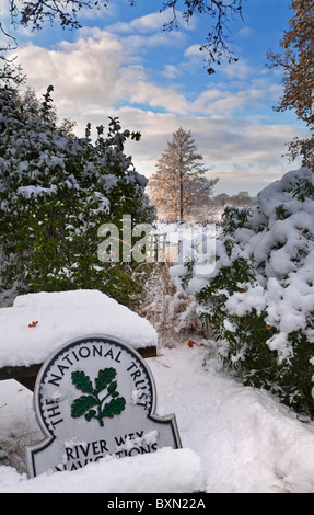 View from private garden to the River Wey with National Trust 'Omega' sign featured and fresh winter snow Surrey  England UK Stock Photo