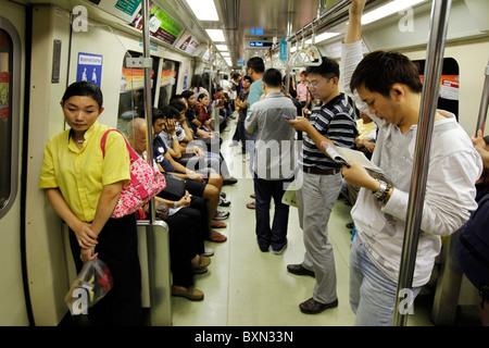 Singapore: Passengers in a car of MRT (Mass Rapid Transport) subway train system Stock Photo