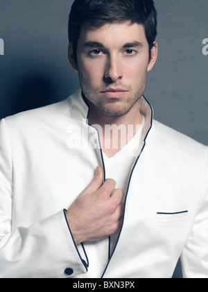 License and prints at MaximImages.com - Fashion photo of a young smiling man wearing a white blazer Stock Photo
