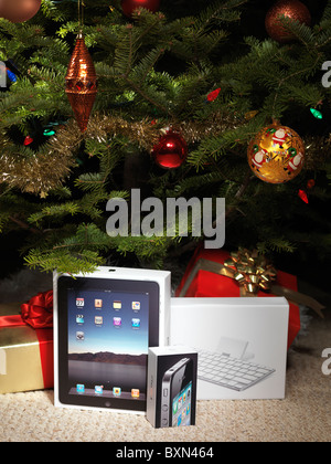 Apple iPad and iPhone 4 amongst presents under a Christmas tree Stock Photo