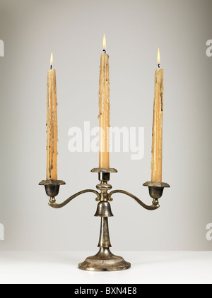 Antique silver triple candle holder candelabra isolated on gray background Stock Photo