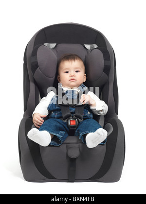Seven month old baby sitting in a booster seat isolated on white background Stock Photo