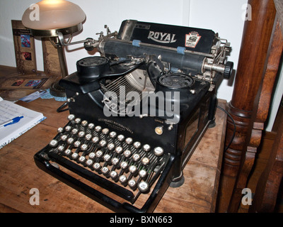 Old 'Royal' typewriter of Swedish make on wooden desk. It is said that Ernest Hemingway used a typewriter of this make. Stock Photo