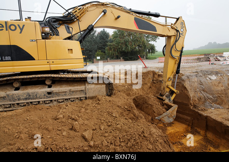 Stock Photo - Large excavator machine working on clearing construction site Belgium Stock Photo