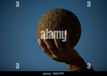 A Mayan ball player holds up the ball made of hule, natural rubber, in Chapab village in Yucatan state in Yucatan, Mexico Stock Photo