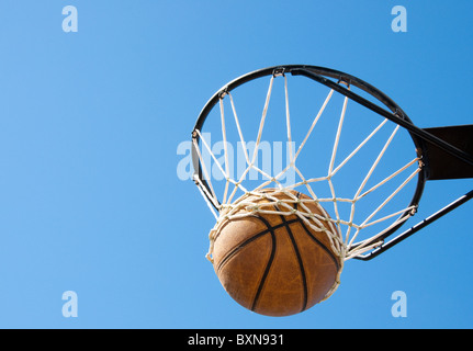 Basketball in the net - abstract concept of success, reaching one's goals Stock Photo