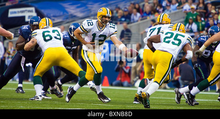 Aaron Rodgers of the Green Bay Packers handing off the football during an NFL game against the Seattle Seahawks Stock Photo