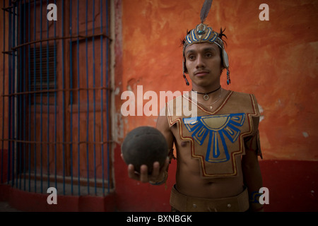 A Mayan ball player holds up the ball made of hule, natural rubber, in Chapab village in Yucatan, Mexico Stock Photo