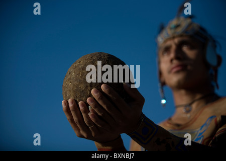 A Mayan ball player holds up the ball made of hule, natural rubber, in Chapab village in Yucatan state in Yucatan, Mexico Stock Photo