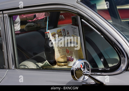 An American Car at a drive in with coke bottle menu and tray Stock Photo