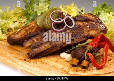 Grilled ribs w pickle lettuce and pepper Stock Photo