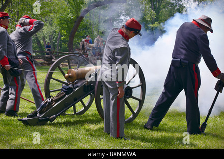 Confederate soldier reenactors fire a 12-pound Howitzer. Stock Photo
