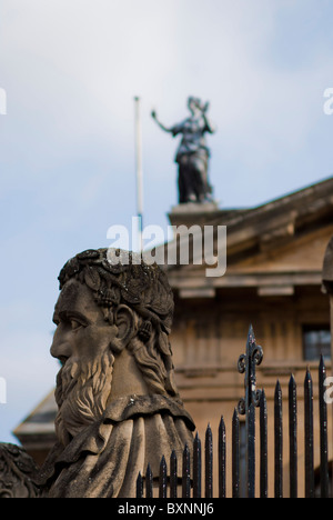 Figure outside the Sheldonian theater, the Clarendon building visible in the background. Broad Street, Oxford, United Kingdom. Stock Photo
