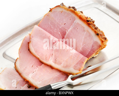 Freshley carved Honey Roast Ham with cloves and brown sugar coating Stock Photo