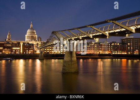 Millenium Bridge over the River Thames at dusk from the South Bank looking towards St Paul's Cathedral, London, Uk