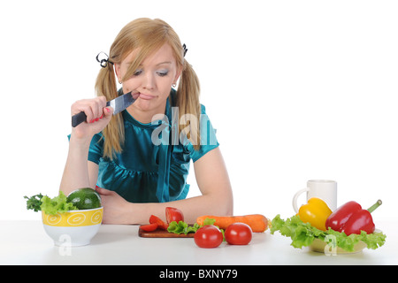 Beautiful housewife with a knife in his hand. Stock Photo