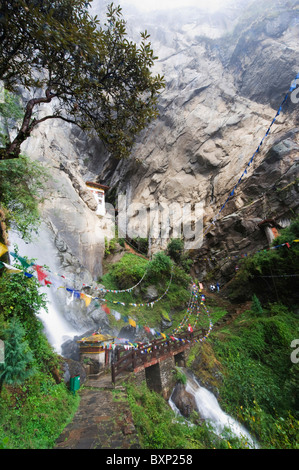 waterfall and prayer flags at Tigers Nest, Taktshang Goemba, Paro Valley, Bhutan, Asia Stock Photo