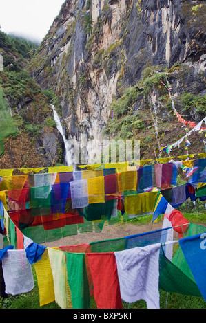 waterfall and prayer flags at Tigers Nest, Taktshang Goemba, Paro Valley, Bhutan, Asia Stock Photo