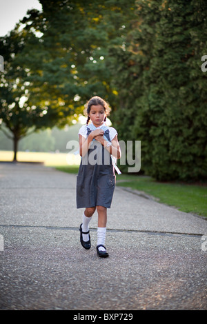 girl walking home from school Stock Photo
