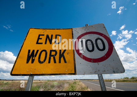 Signs indicating end of road work and speed limit of 100 kph Stock Photo