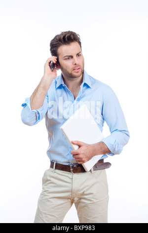 businessman with laptop and cellphone standing - isolated on white Stock Photo