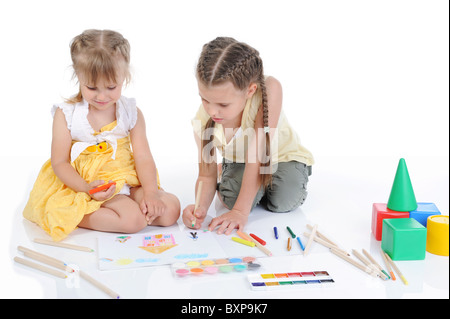 Two sisters draw on the album. Stock Photo