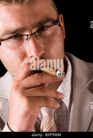 Businessman smoking cigar Stock Photo