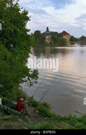 Angler sitting on a bank of the Oder, Wroclaw, Poland Stock Photo