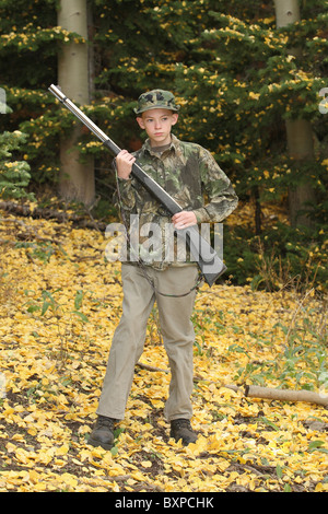 young preteen hunter in deer woods in fall Stock Photo