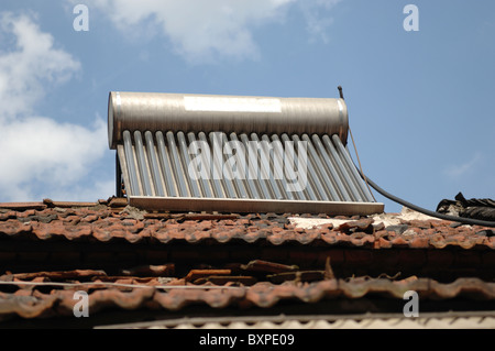 A n environmentally friendly solar water heater on the tiled roof of a house in Yangzhou Jiangsu Province of China Stock Photo