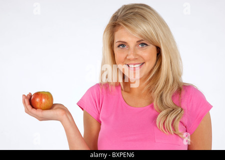 Young caucasian blond Woman holding apple showing a healthy lifestyle Stock Photo