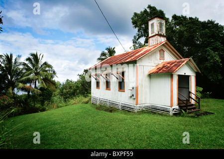 An old corrugated iron missionary church rusting away on the tropical island of Hawaii's big island in the rain forest. Stock Photo