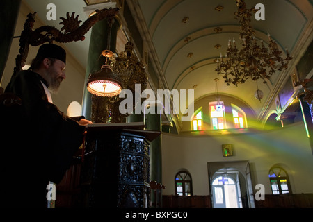 Greek Orthodox priest during the evening service, Heybeliada, Turkey Stock Photo