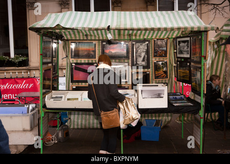 UK, England, Yorkshire, Leeds, Albion Place Christmas Crafts Market, woman browsing at photograph stall Stock Photo