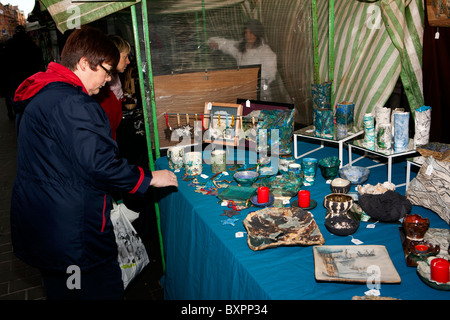 UK, England, Yorkshire, Leeds, Albion Place Christmas Crafts Market, shoppers at Kath Bonsons ceramics stall Stock Photo