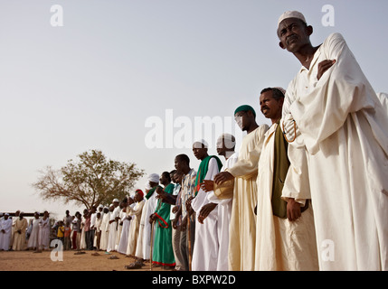 Locals line up at a ceremony in Omdurman Sudan to celebrate the Mahdi at the place of his tomb. Stock Photo