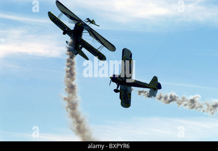 Two stunt biplanes, one with a wing-walking performer Stock Photo