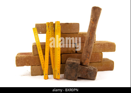 bricks and measuring tool to build a wall or making pavement Stock Photo