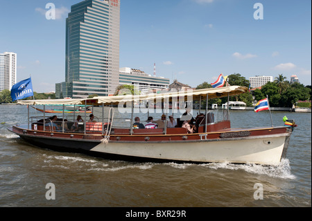 The Chao Phraya river is the royal river cutting through Bangkok and full of different types of boats and other river transport. Stock Photo