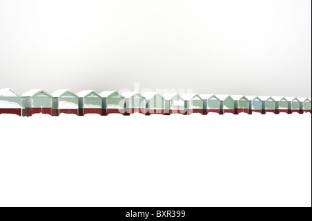 A row of beach huts covered in snow Stock Photo