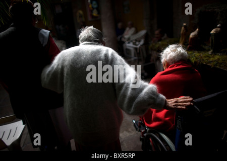 A nurse helps Isabel Alarcon, 100, walk during the celebration of her one hundred year's old birthday in Mexico City Stock Photo