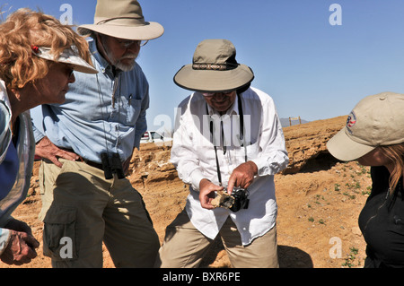 Geologist showing cinder bomb with glass rind, Cerro Colorado Crater, El Pinacate Biosphere Reserve area, Sonora, Mexico Stock Photo