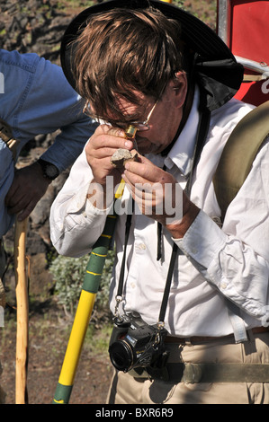 Geologist viewing rock with hand lens, El Pinacate Biosphere Reserve, Sonora, Mexico Stock Photo