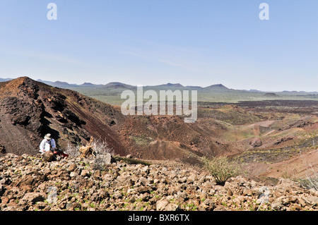 Geologist taking notes while viewing interior of Tecolote cinder cone, El Pinacate Biosphere Reserve, Sonora, Mexico Stock Photo